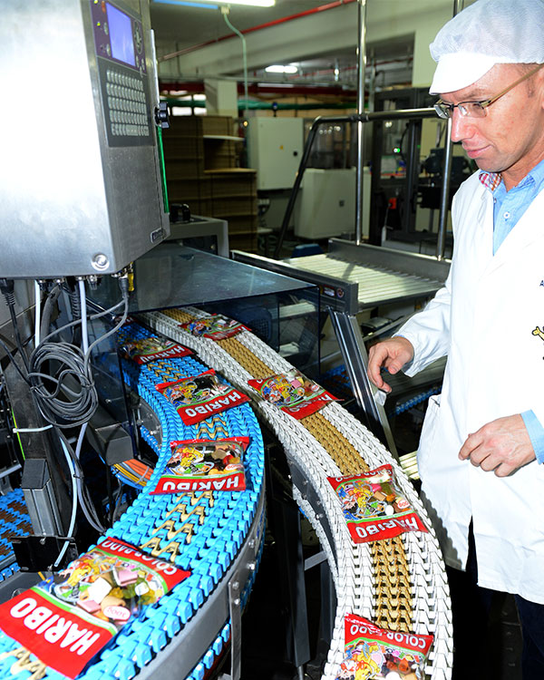 A man works on a Haribo manufacturing line.