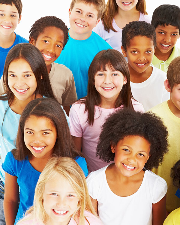 A group of kids look up and smile.