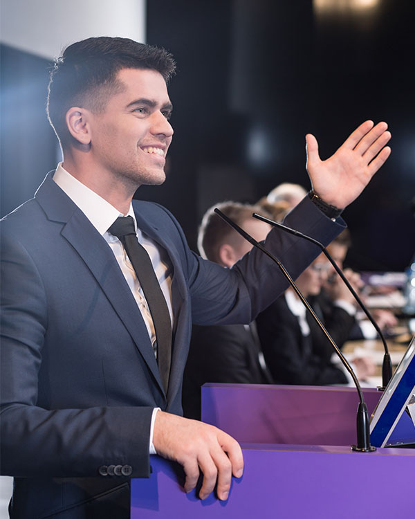 A young man speaks at a podium