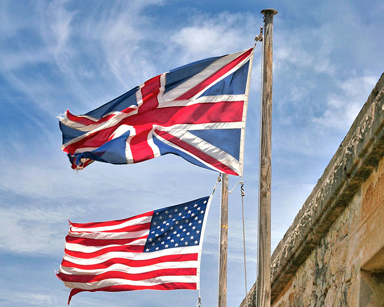 The American and British flags hang from poles.