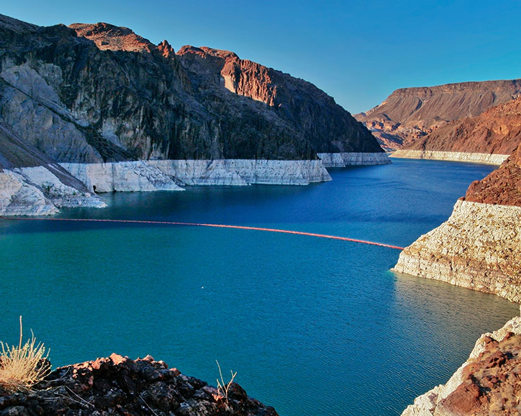 A dam with a receding water line.