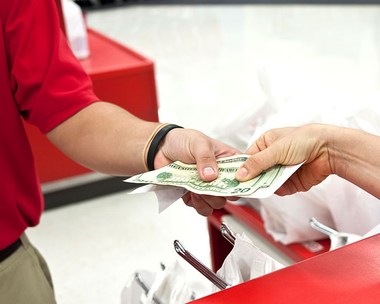 Two people exchange money and a receipt