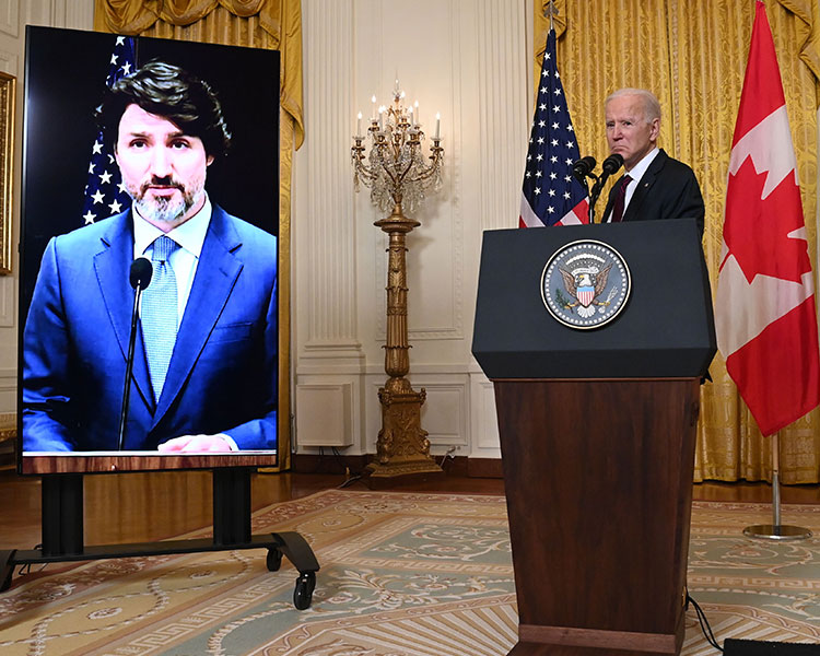 President Biden frowns while on a video call with Prime Minister Trudeau