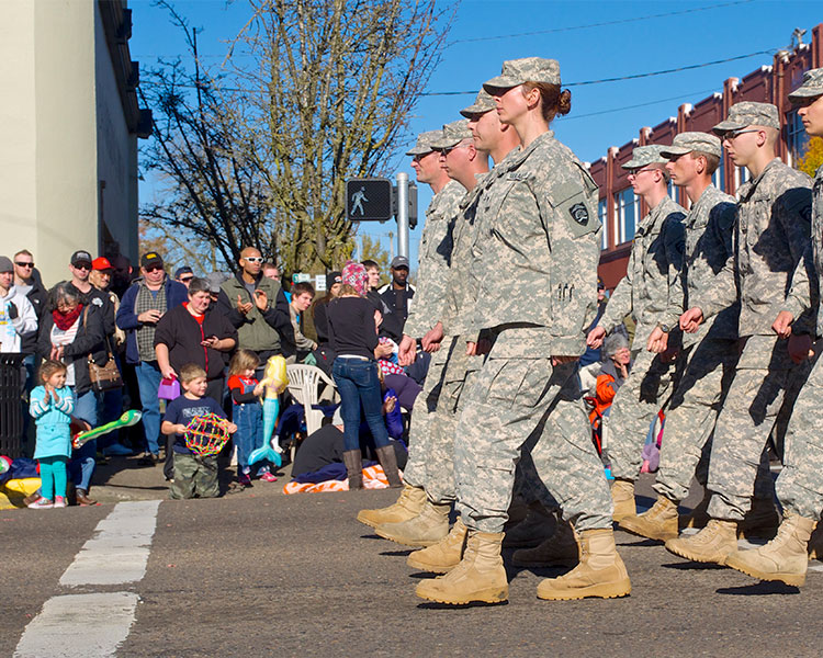 Soldiers walk in the street.