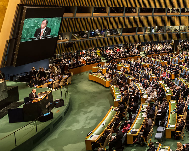 A room filled with people sitting at long tables