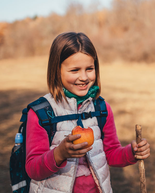 Girl holding an apple.