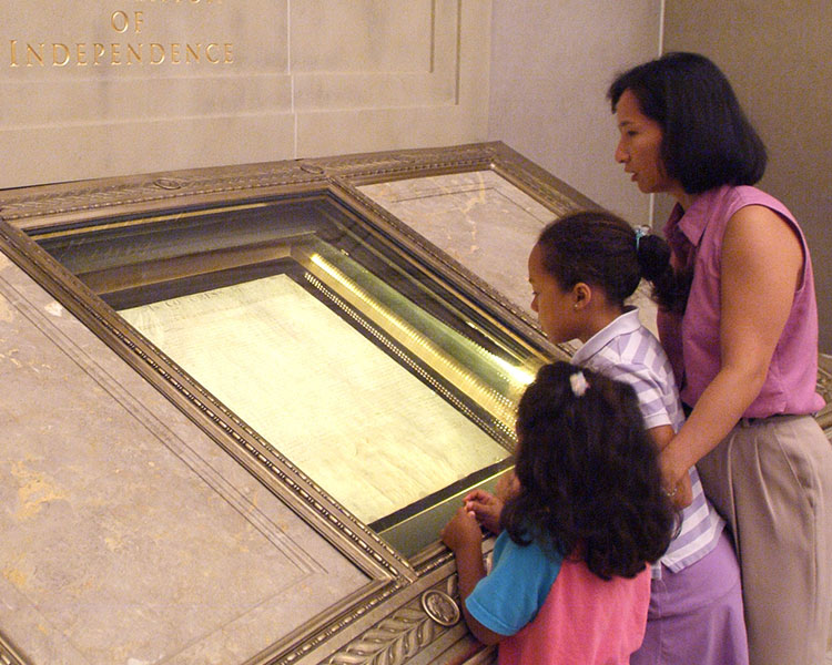 Children at a museum looking at ancient artifacts