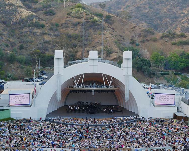 A stage with a large curved dome over it and curving rows of seats in front of it