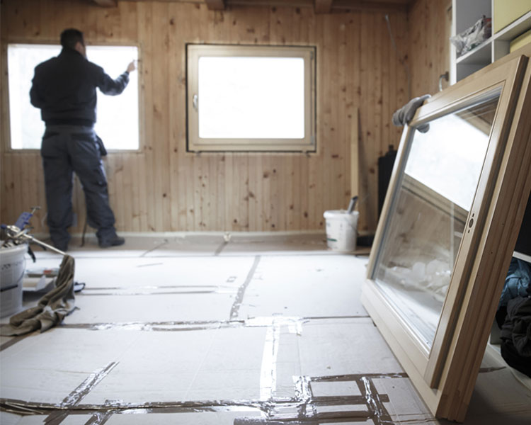 A man repairing the inside of a house