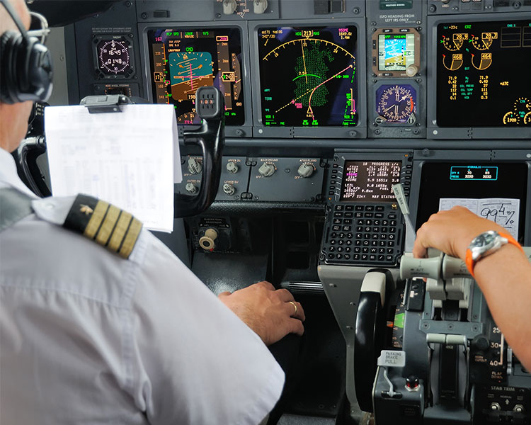 Pilot in front of the plane control system