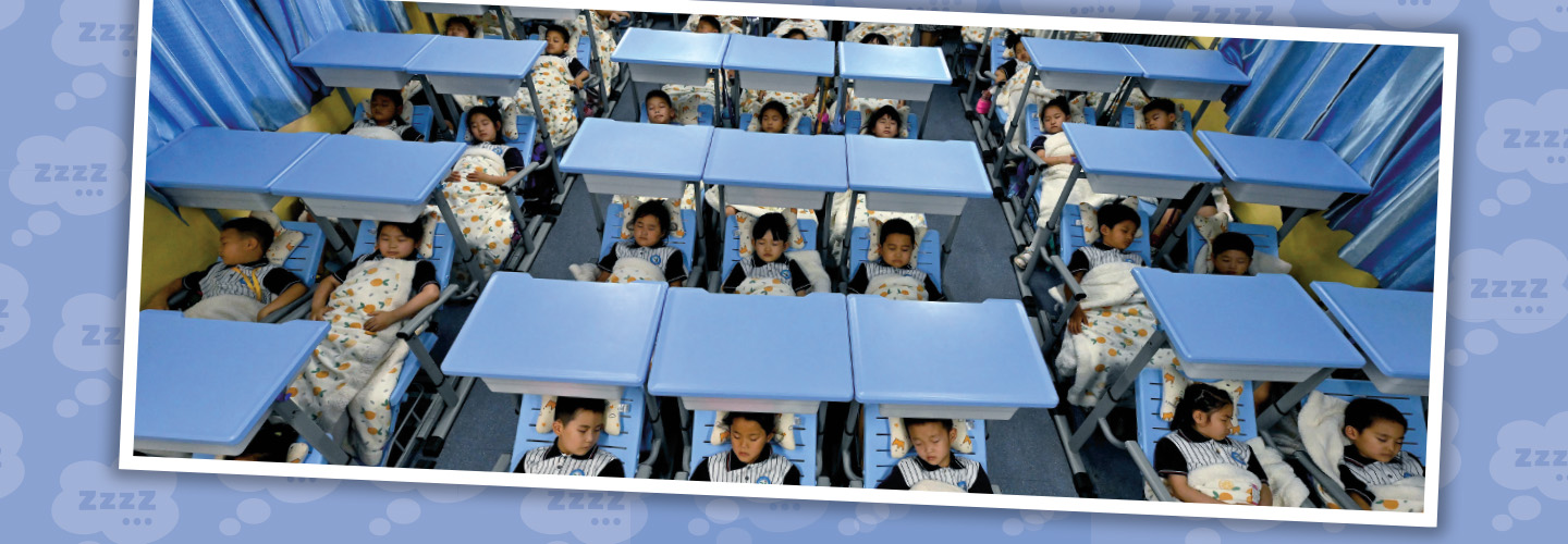 Photo of rows of students taking naps in beds during school