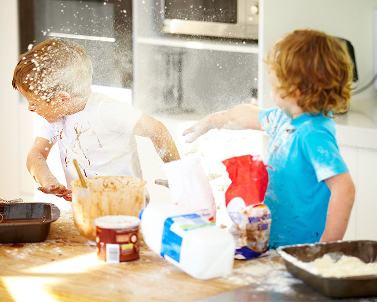 Children throwing flour at each other