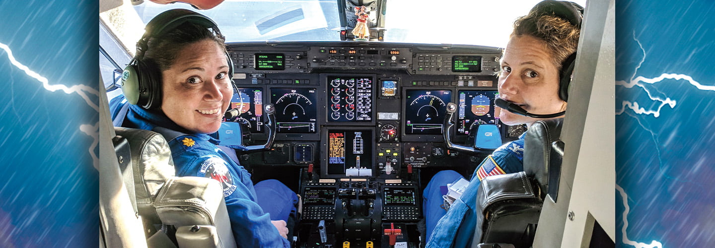 Photo of two pilots driving a plane against a backdrop of lightning