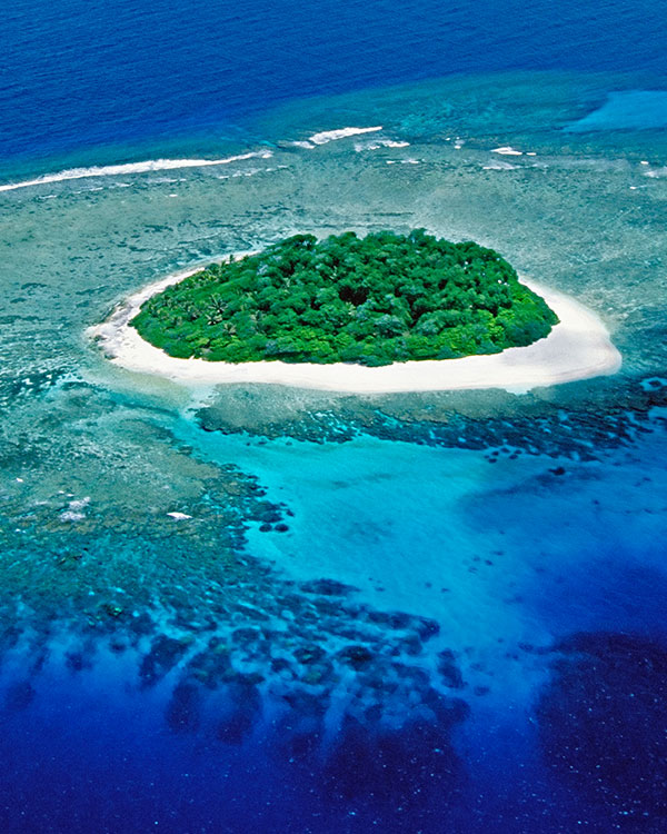 Island surrounded by clear blue water