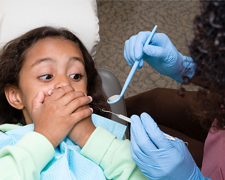 A kid covering their mouth so dentist can&apos;t use tools on their teeth