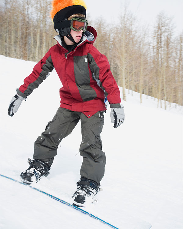 Image of a kid snowboarding