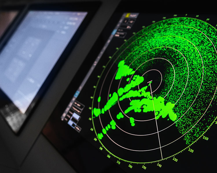 Photo of a radar lit up with green lights displayed on a screen