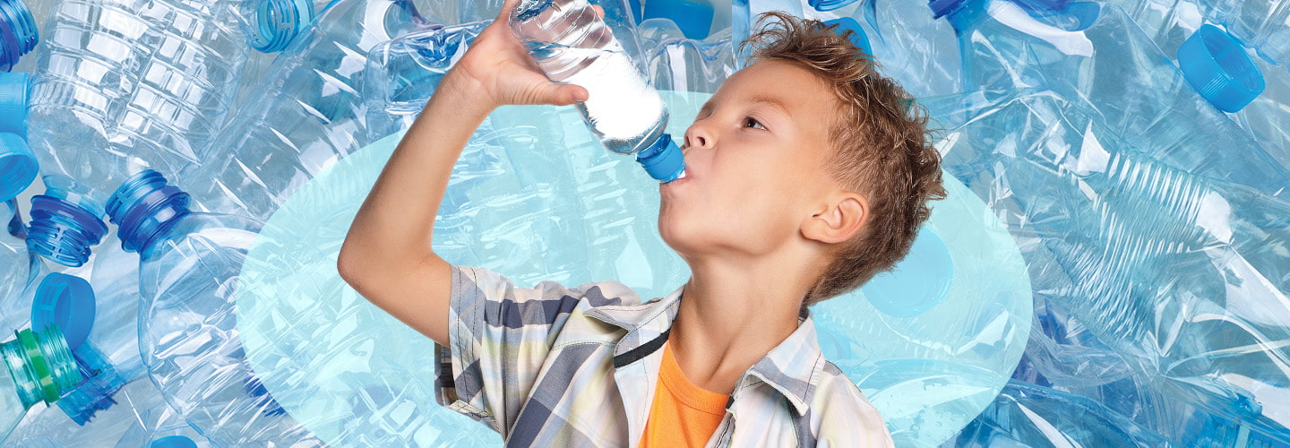 Image of a kid drinking from plastic water bottle against backdrop of plastic water bottles