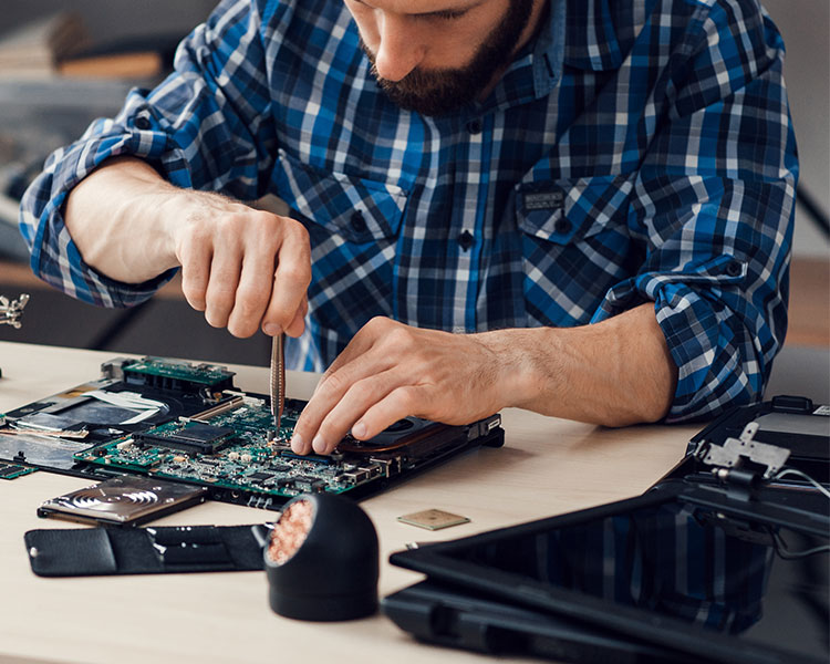 Photo showing a person fixing the internal part of a computer