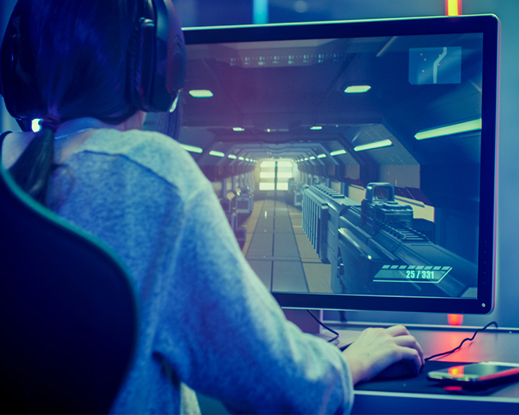 Image of a person playing a desktop videogame