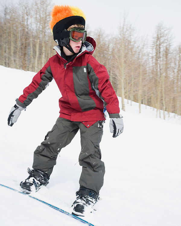 Image of a kid snowboarding