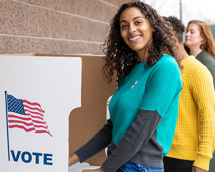 Photo of people voting at a voting booth