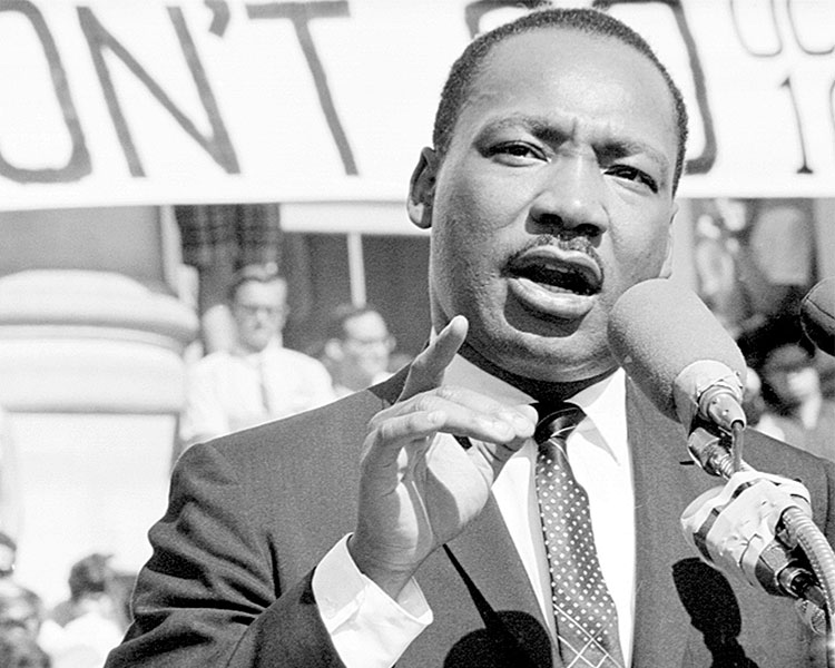 Black & white photo of Martin Luther King Jr. giving a speech